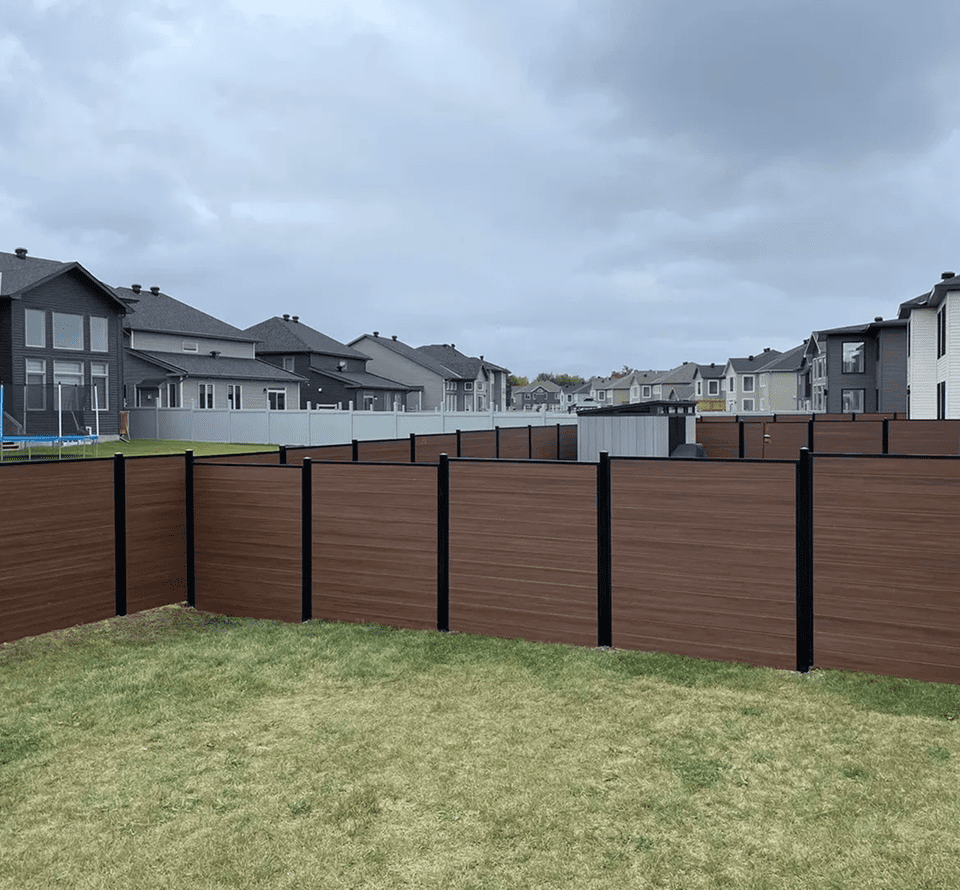 image Suburban backyard with brown wooden fence.