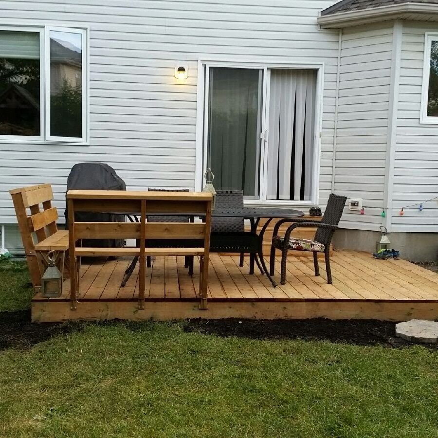8627 Wooden deck with chairs in backyard.